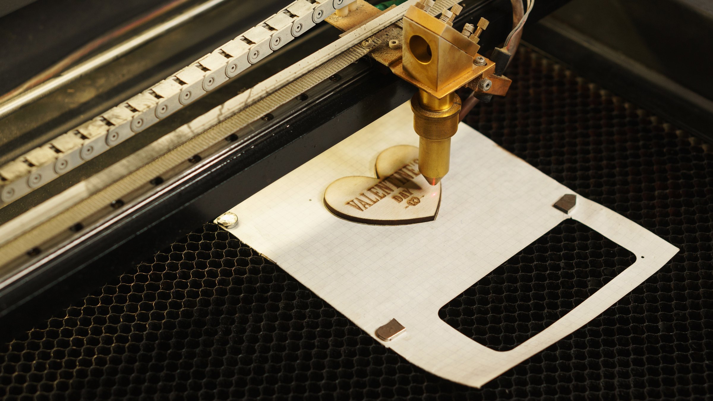 Laser Cutting Beam over Plywood Sheet